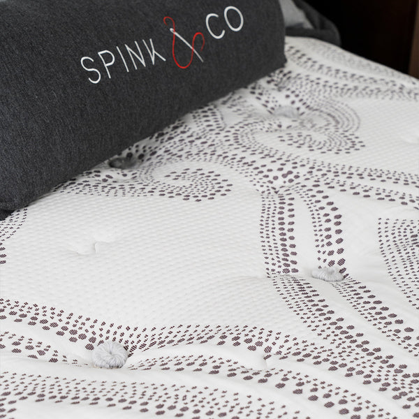 Spink & Co Padworth Firm mattress cover showing hand tufted poufs and fabric pattern.