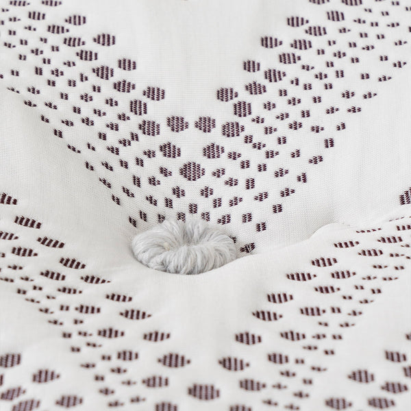 Spink & Co Warwick Euro Top mattress Cover fabric closeup of hand tufted pouf