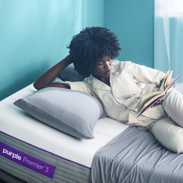 Woman Reading Book And Relaxing ON The Purple Hybrid Premier 3 Mattress