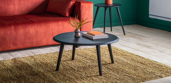 Black Coffee Tables on a rug with a red sofa in the background