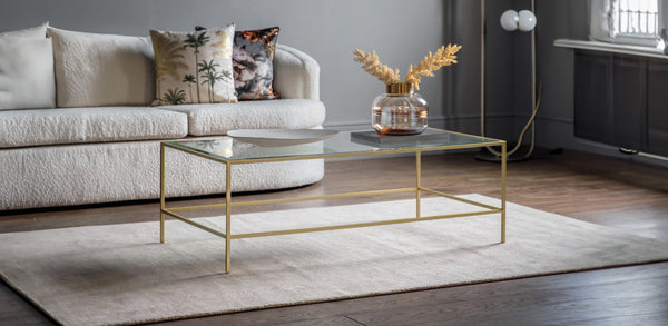 Glass Coffee Tables on a white rug with sofa in the background