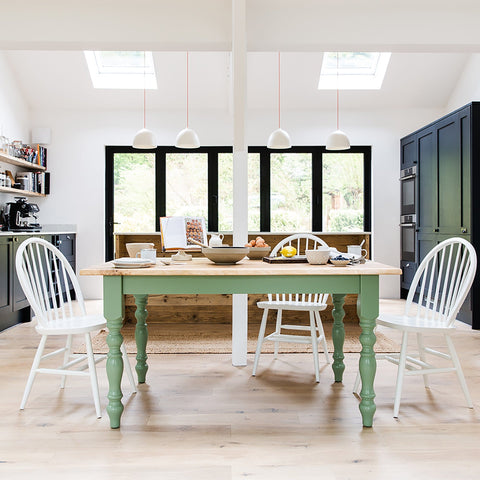 A kitchen with a Kiki French Dining Table With Rustic Oak top and chairs.