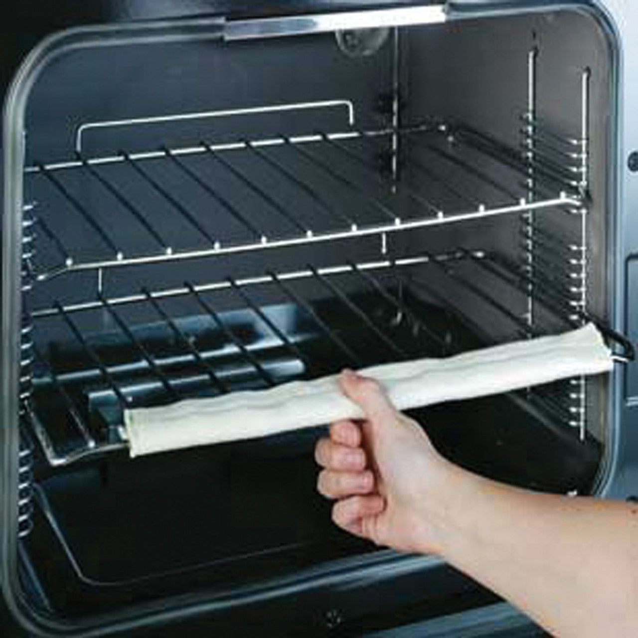 Single Cover Oven Rack Guard connected to a rack inside of an oven.