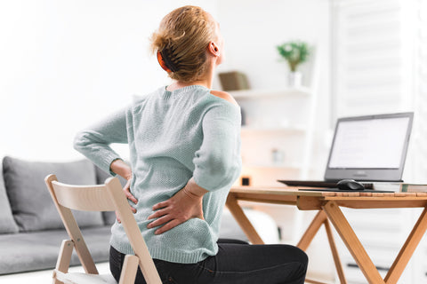 woman clutching on her achy lower back