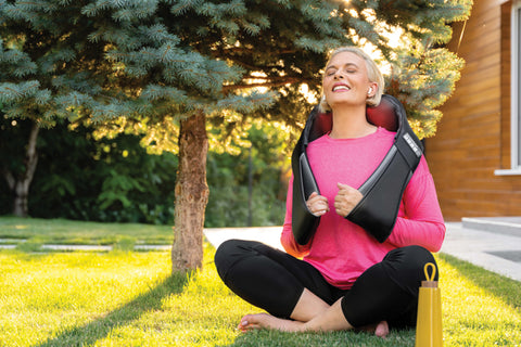 woman using electric massager outdoors