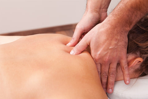 professional masseur performing shiatsu massage on patient