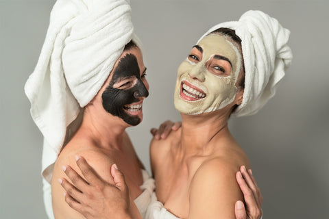 two women enjoying their spa day while wearing beauty face masks