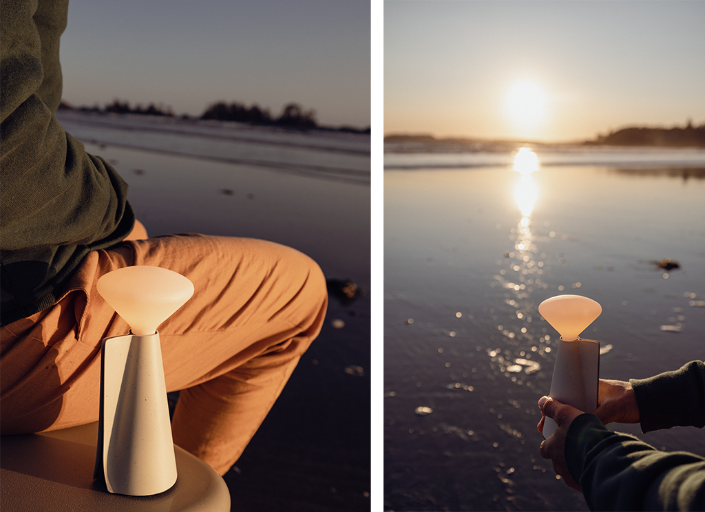 Man sitting by a lake watching the sunrise