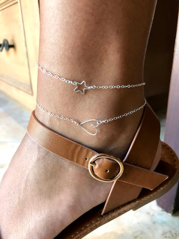 beth jewelry dainty handmade silver star and heart anklets on ankle with strappy brown sandal