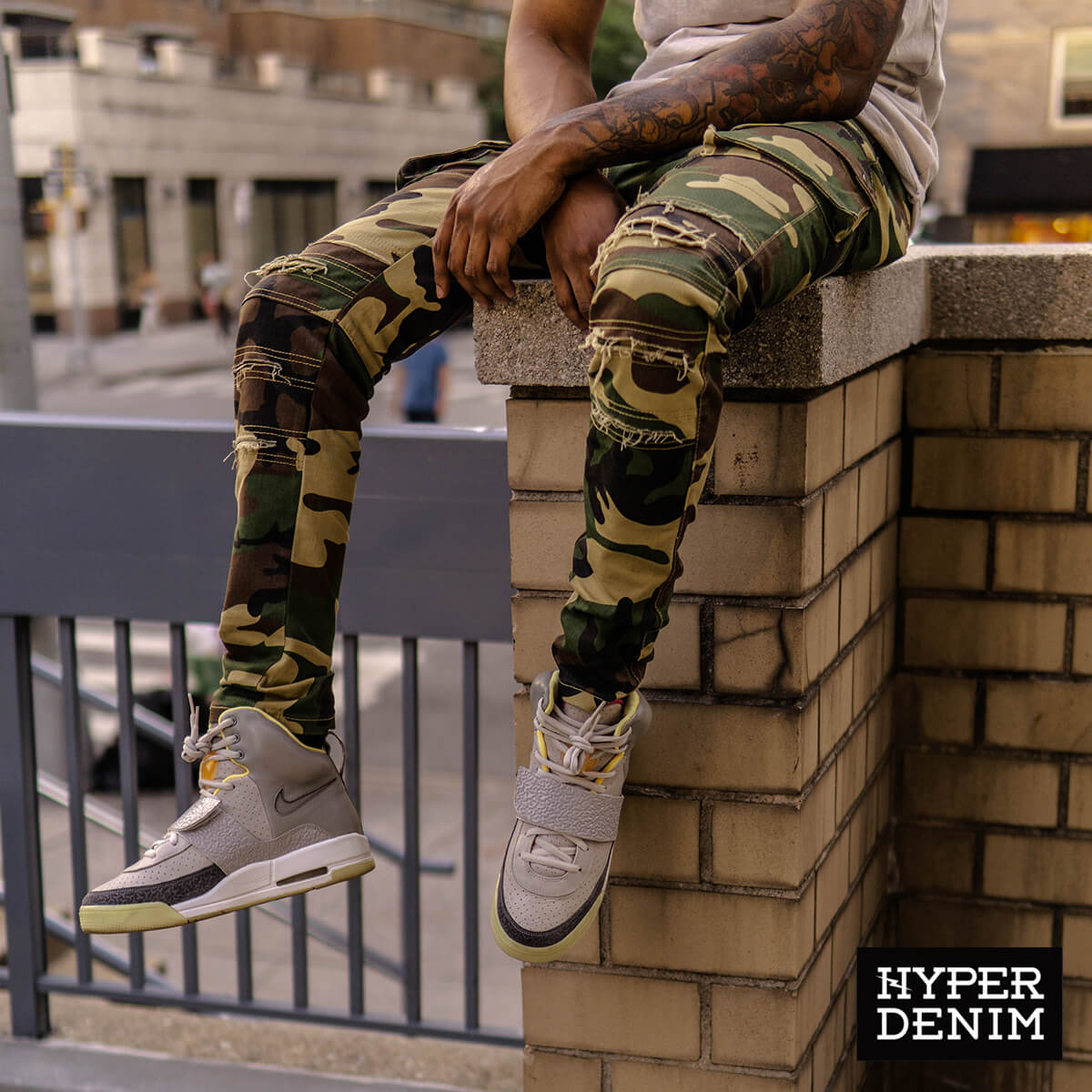 tattooed guy wearing distressed camo pants