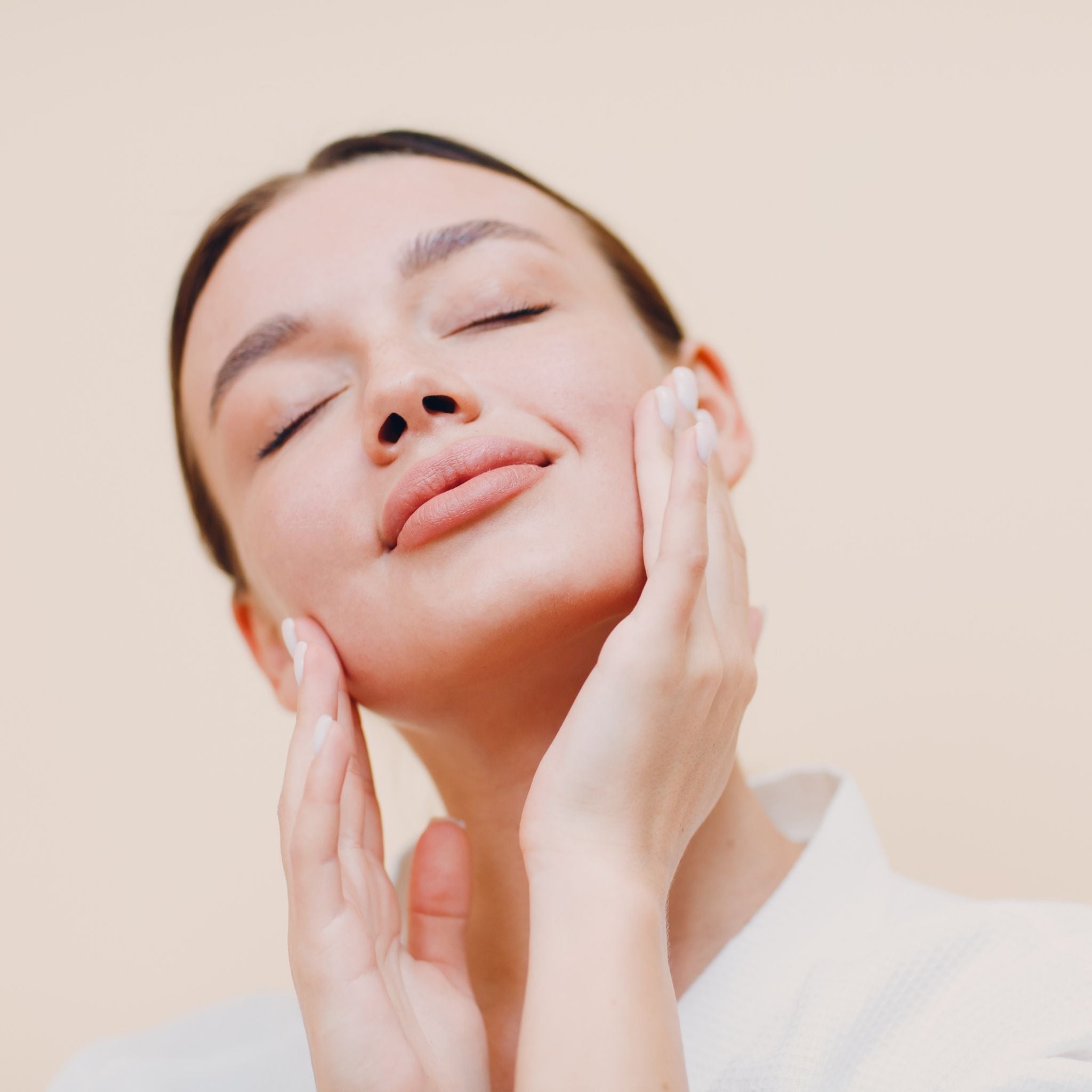 Woman touching her face with a worried expression, representing reactive skin and skin sensitivity