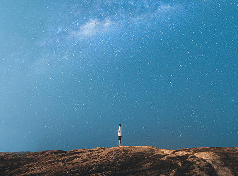Picture of man gazing up at a starry sky.