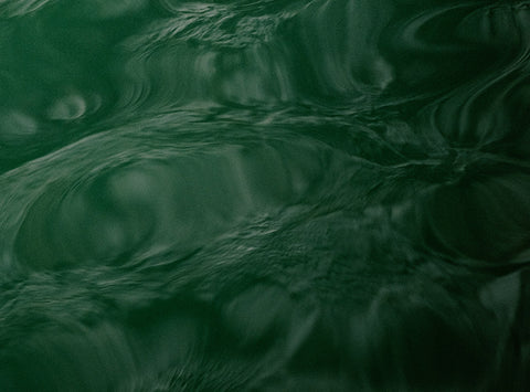 Image of green water with ripples.
