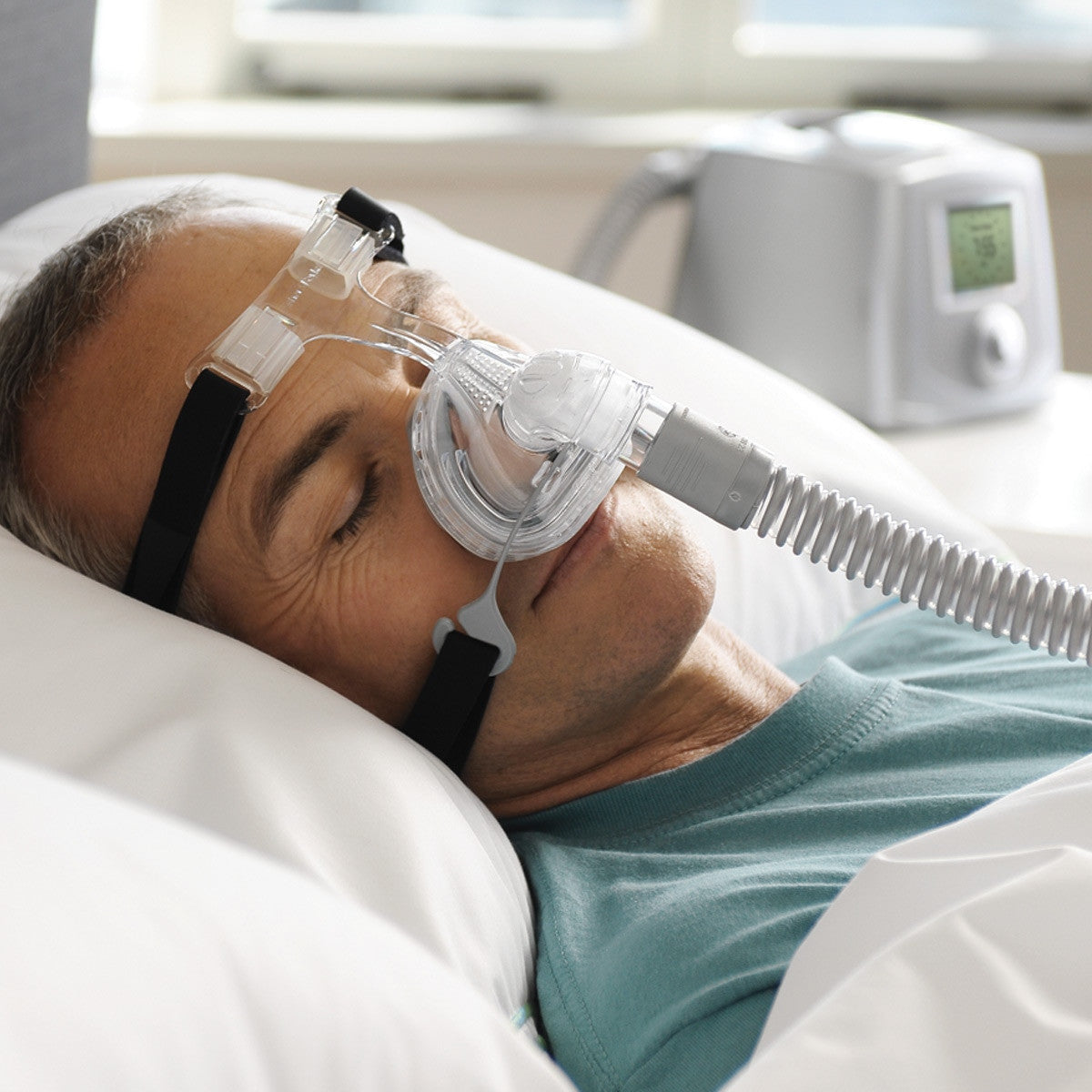 man sleeping with CPAP mask