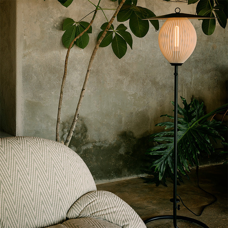 Gubi Satellite Outdoor Floor Lamp emits warm and pleasant glow through perforated metal shade