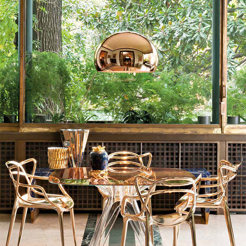 Kartell FL/y pendant Metallic copper above dining table