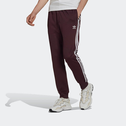 Adidas Classics SST Track Pants: Weinrot - Kaufe deine STAB Trainingshose im Streetwear Shop Berlin, Sneaker Store Berlin.