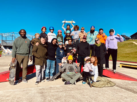 Group of skaters posing together of all ages