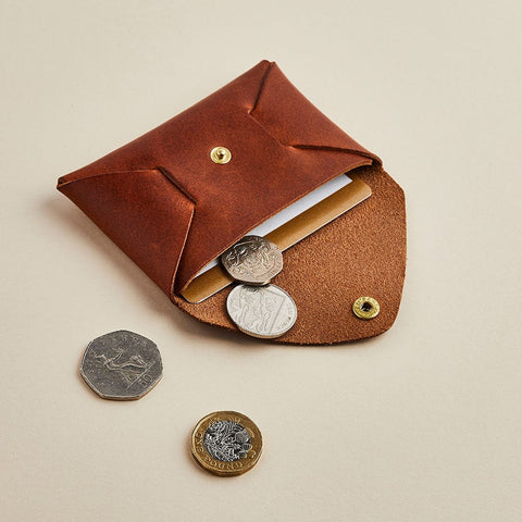 Brown leather coin pouch, shown with coins and cards, by Man & Bear