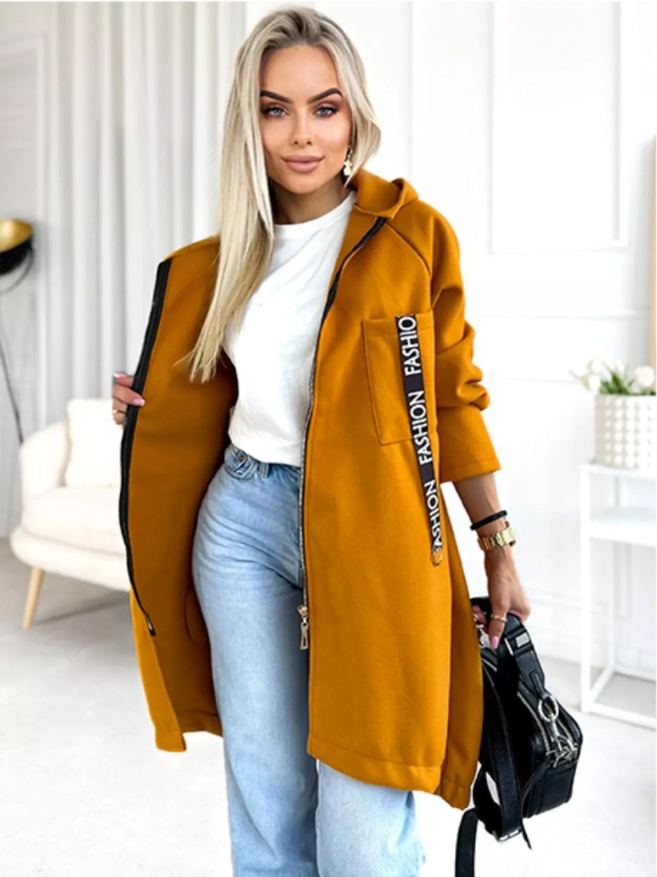 Woman wearing zip-up longline hooded jacket, casual everyday style