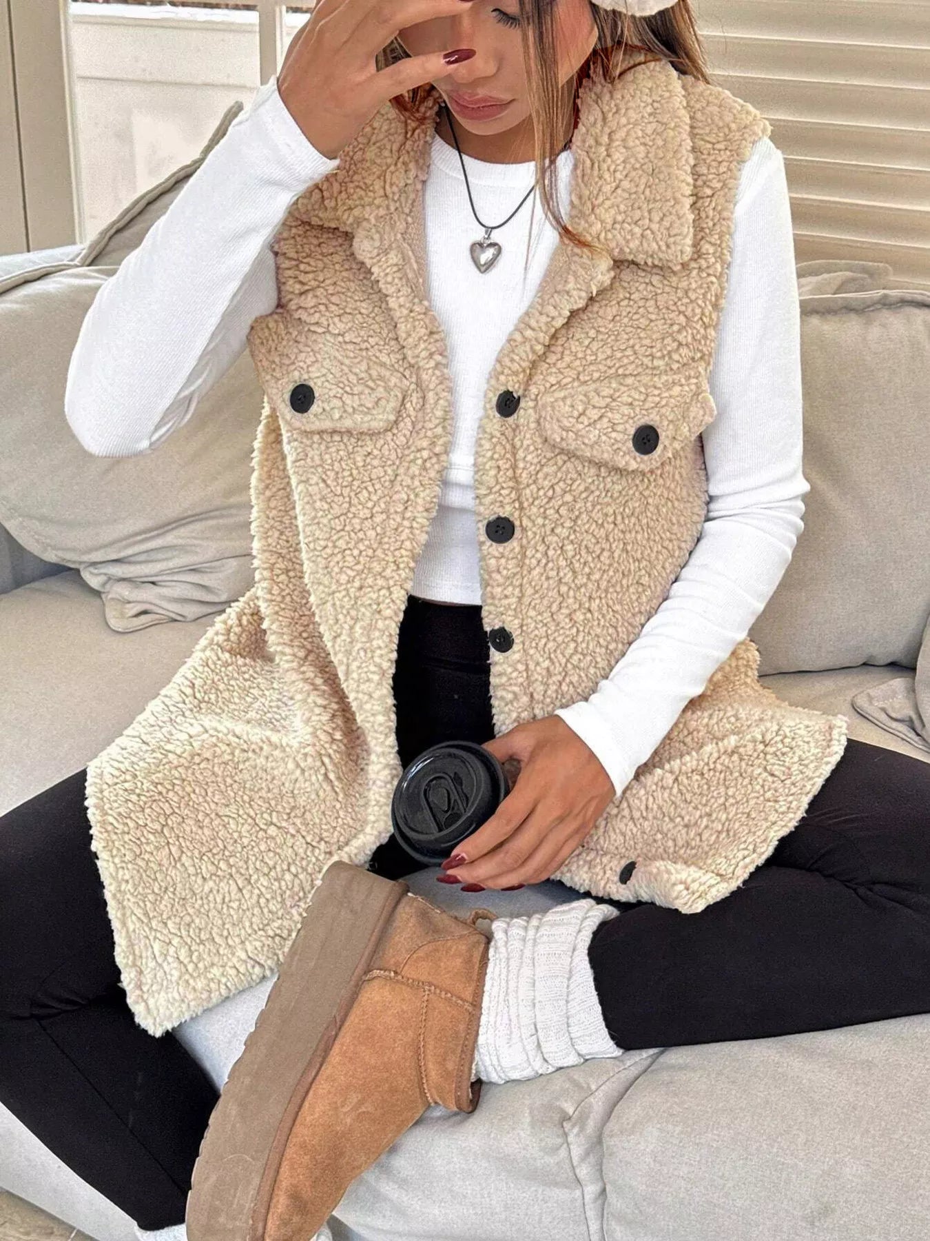 Apricot sherpa vest showing soft fleece texture and button detail
