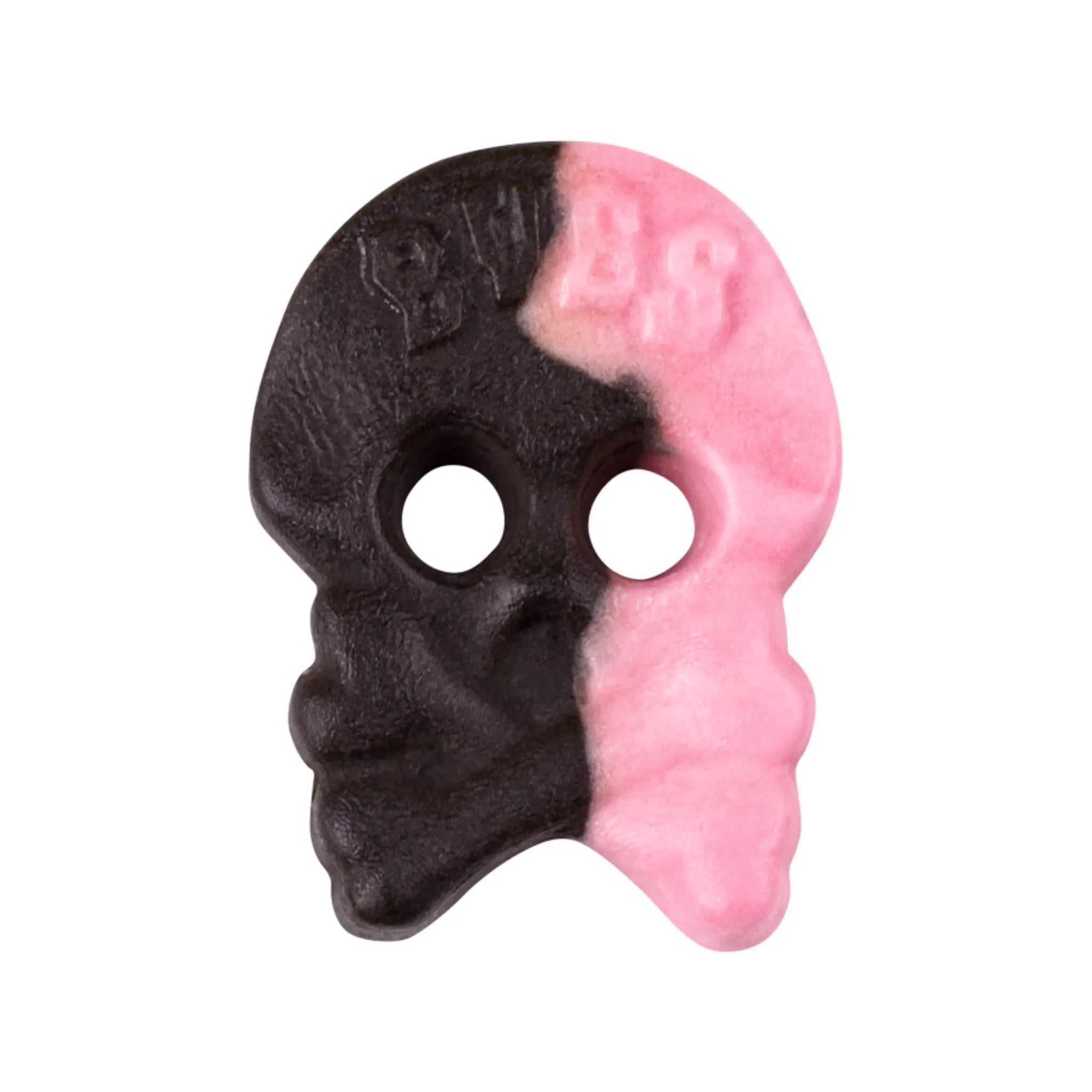 Swedish candy in the shape of a skall, half black and half pink.