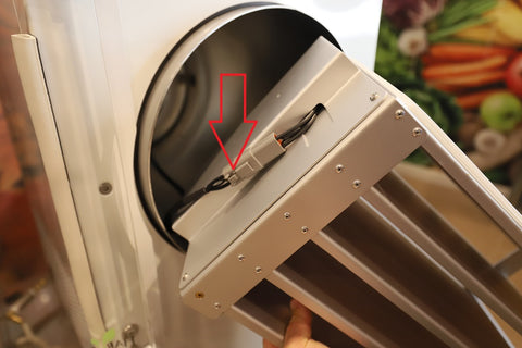 The pigtail, are the two plastic pieces where the shelving unit, and wire from your machine connect. There is a little button that needs to be pushed in to separate the two so you can remove your shelving unit.