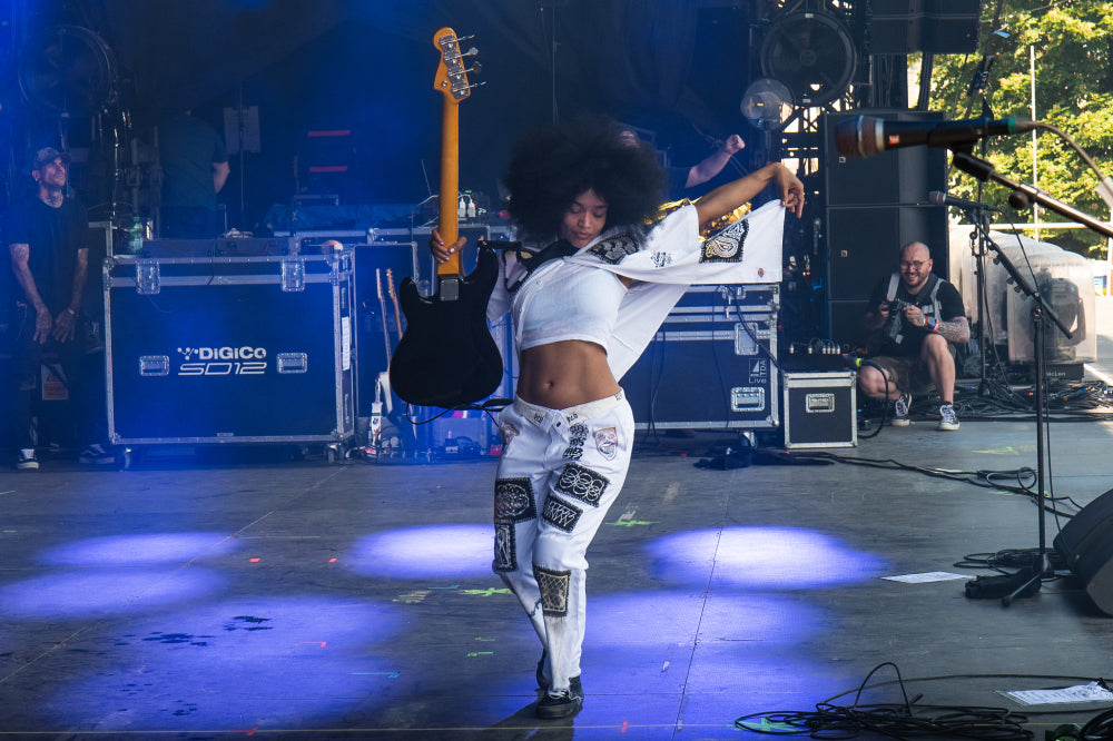 April Kae rocking out on stage / Image by @bandgedoe display: full