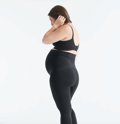 Pregnant woman wearing Knix black maternity leggings