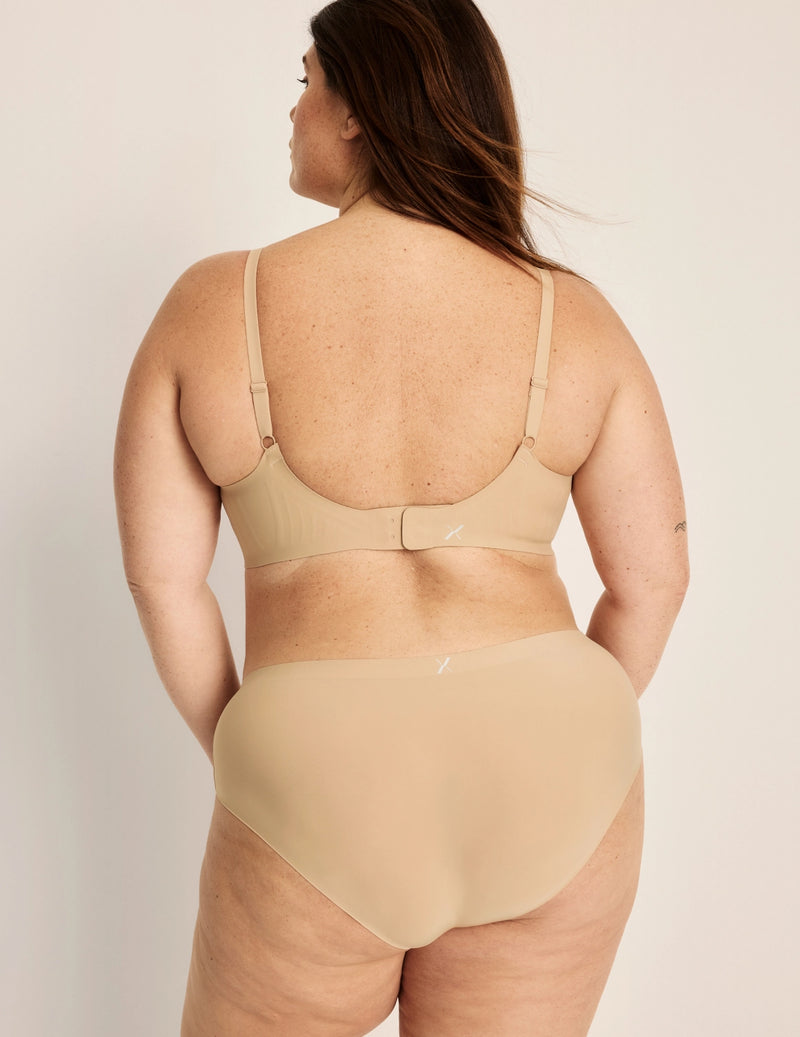 Clementine has 51” hips, and wearing KNIX XXL