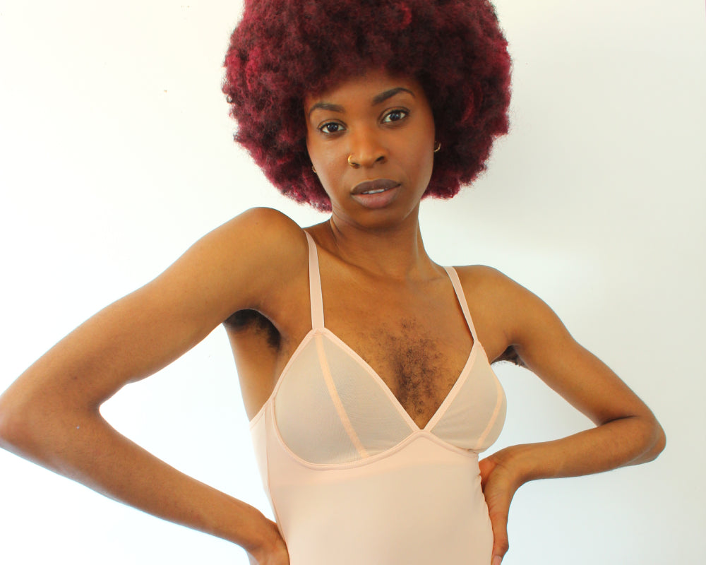 Queen Esie wearing the Mesh Deep-V Bodysuit in Peony from the Ashley Graham x Knix Collection display: full