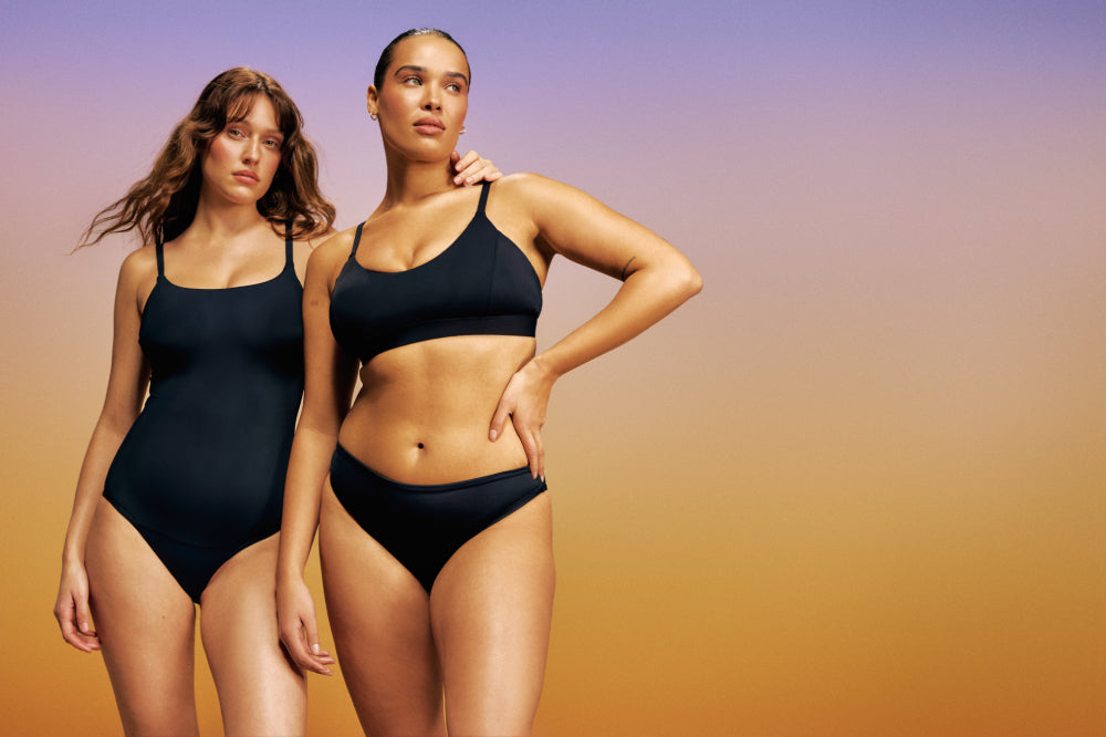 Knix models wearing the Leakproof Classic One Piece Swimsuit and Leakproof Bikini Bottom in Black display: full