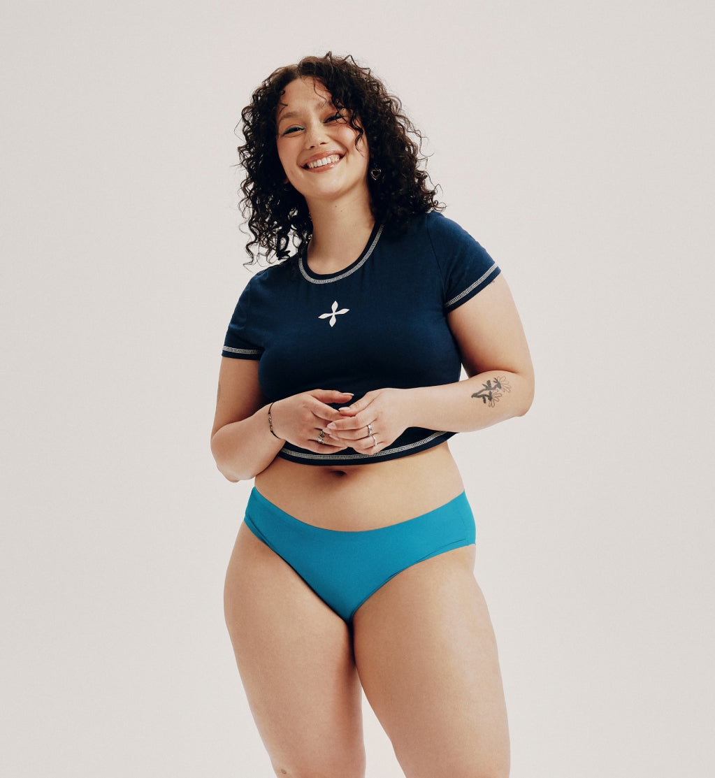 Young beautiful plus size model in underwear, xxl woman on black