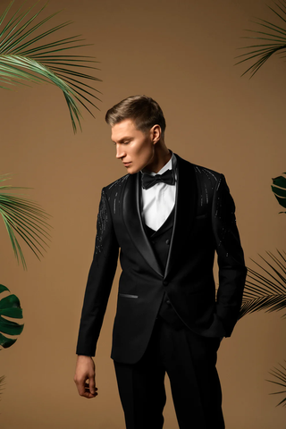 A man dressed in a black tuxedo