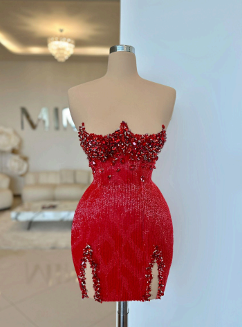 A short red dress with red crystals on a doll