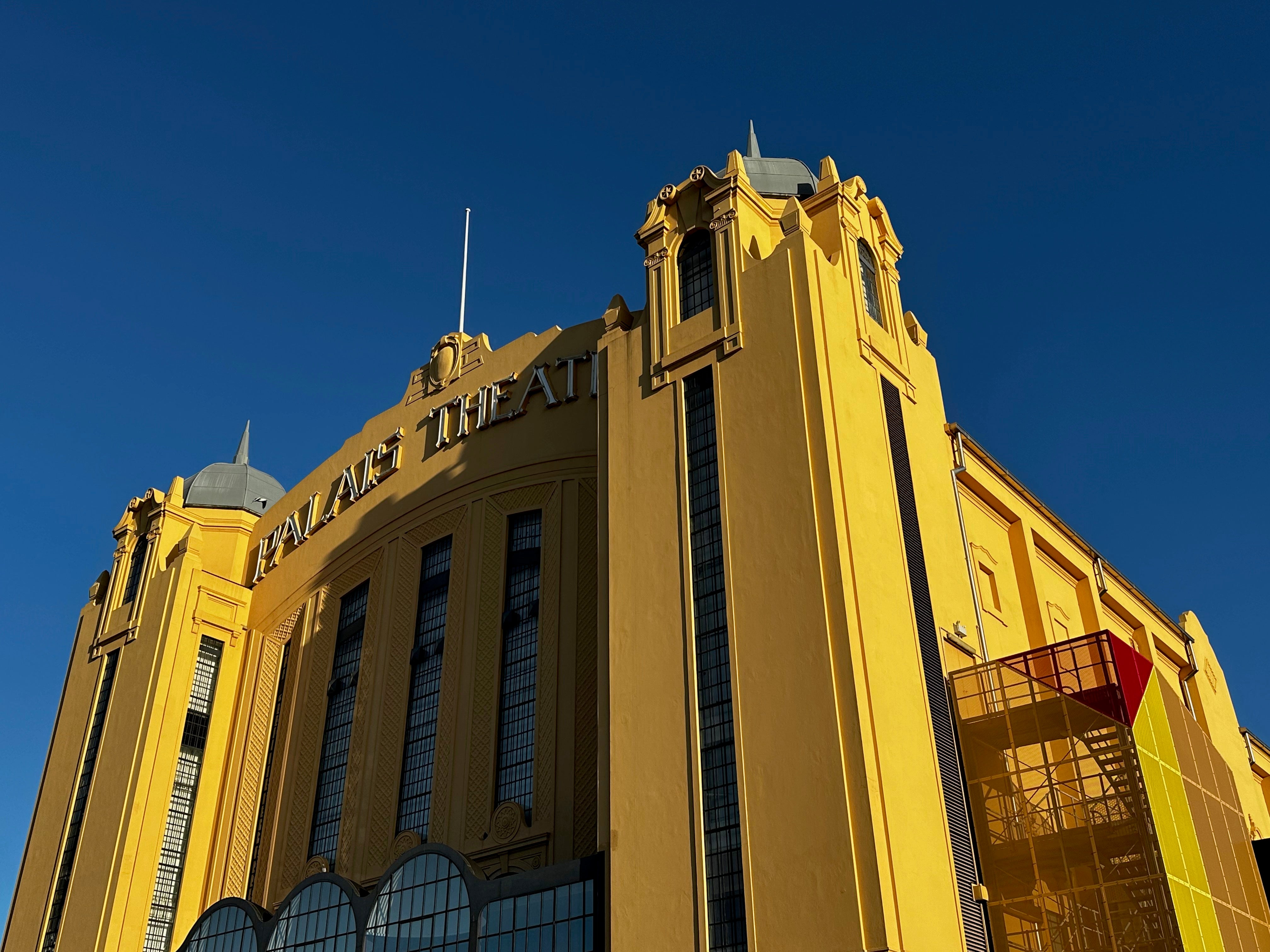 Majestic theatre sun tipped in the golden hour against a vivid blue sky