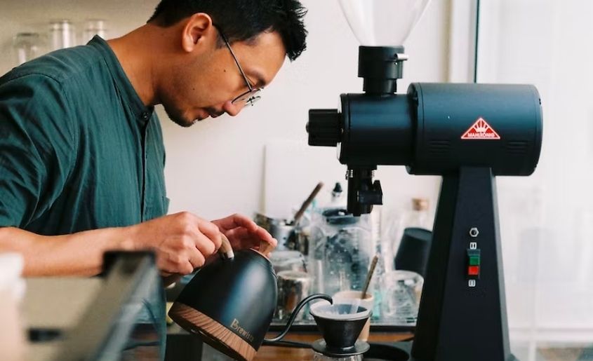 A man brewing coffee