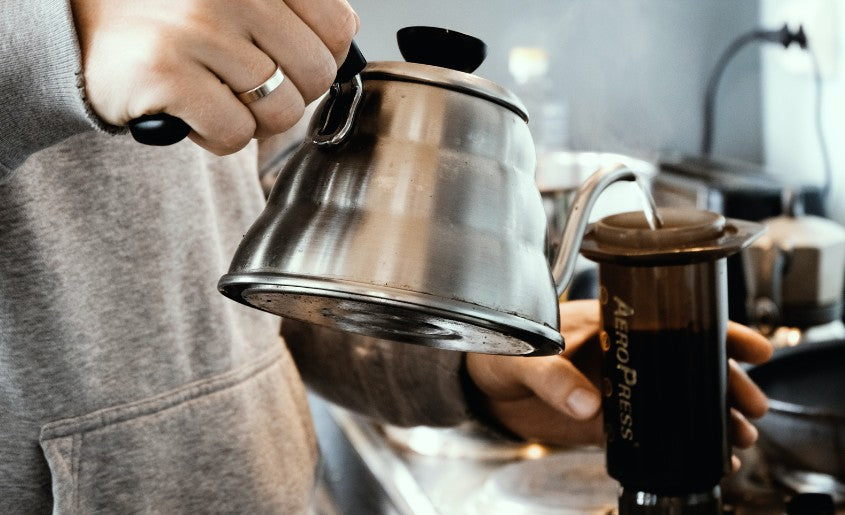 Man Making Coffee With AeroPress