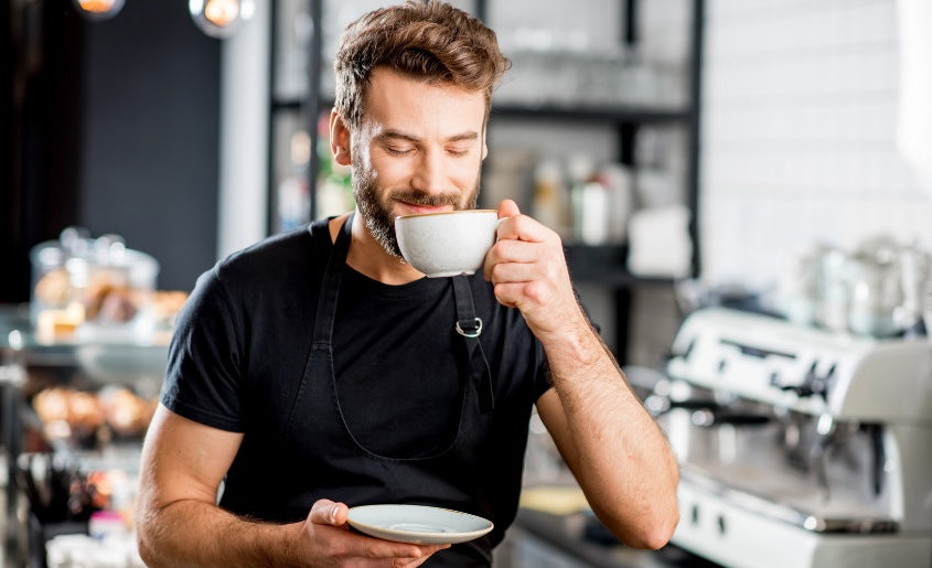 Man sipping coffee infused with Lion's Mane