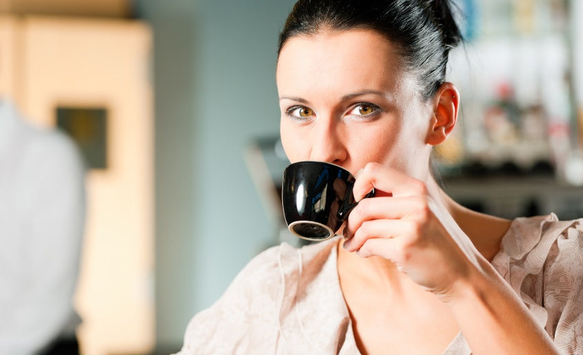 Woman Sipping From Cup With Mushroom Supplement 1