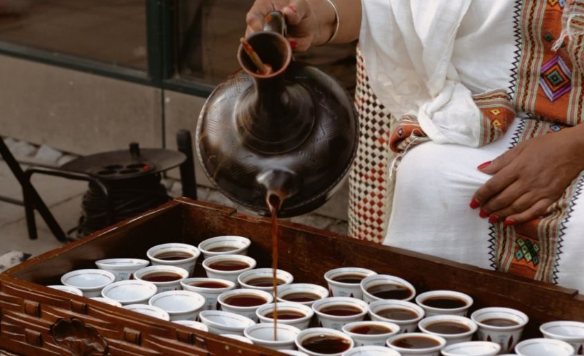 Lady is pouring coffee in pots