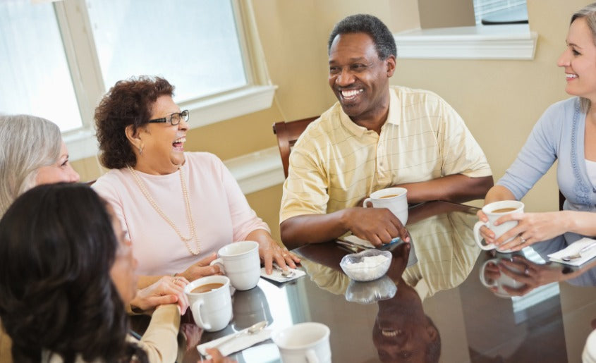 men and women drinking coffee at home