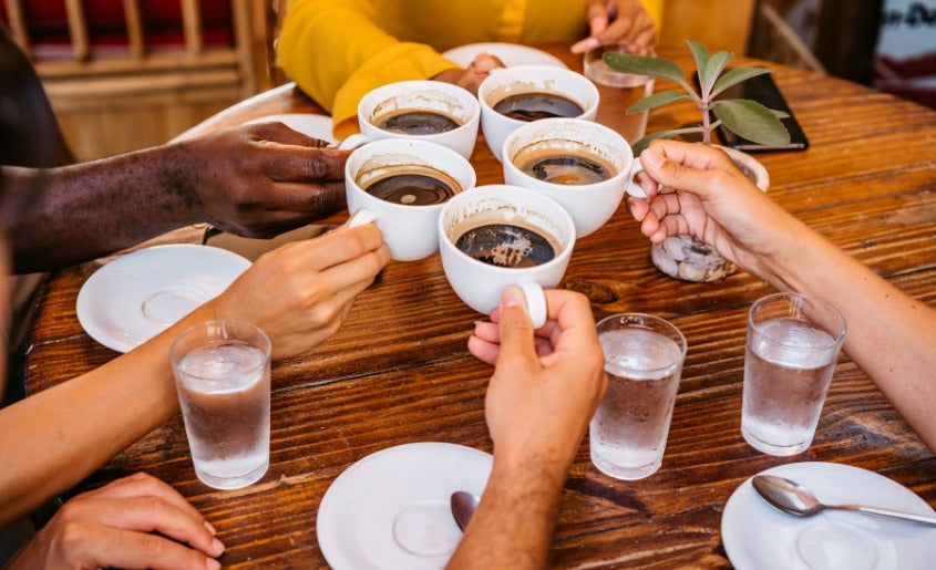 men and women drinking coffee at home Best Lion's Mane Coffee