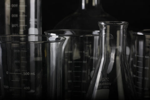 Glass beakers with a black background