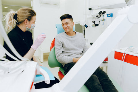 A dental patient smiling at his dentist