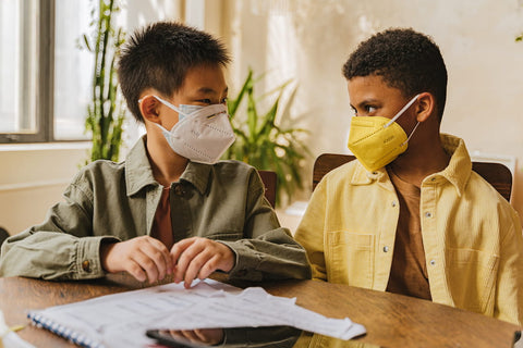 Two children wearing masks