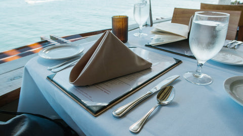 A folded napkin on a table in a restaurant