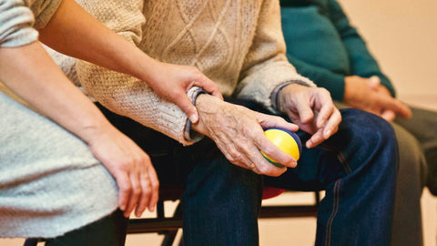 Two elderly people holding hands