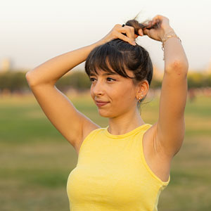 Young woman tying up hair to do sport