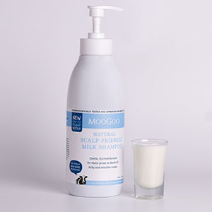 Image of MooGoo Milk Shampoo bottle with small glass of milk next to it